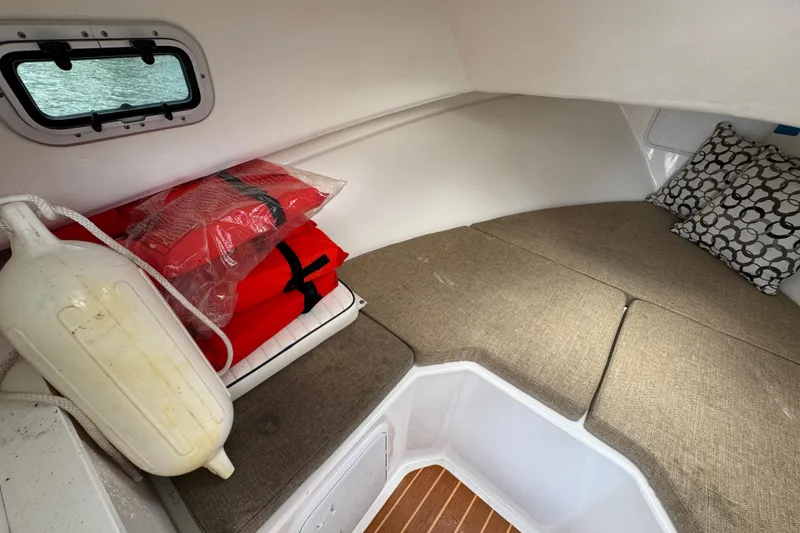 Slide: The Image of 2019 Steiger Craft 255 Miami cabin interior with life jackets and cushions. - 21