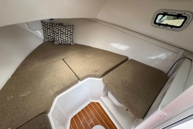 Slide: The Image of 2019 Steiger Craft 255 Miami cabin interior with cushions and patterned pillows. - 22