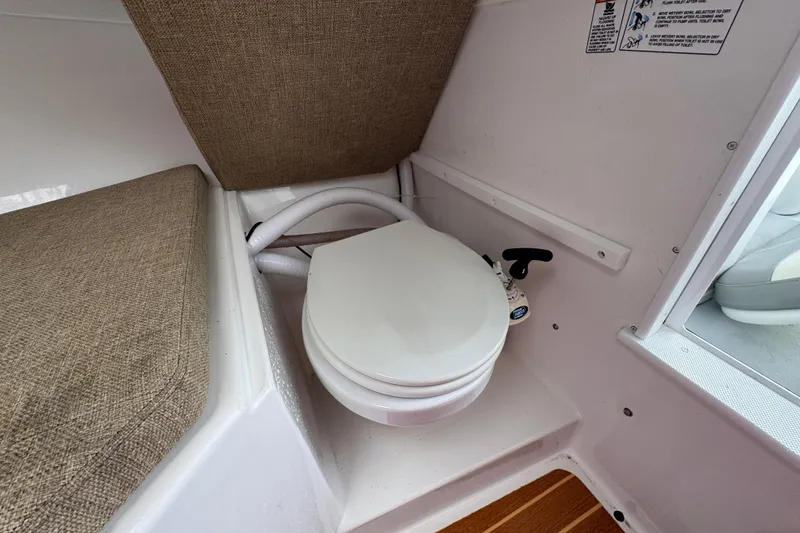 Slide: The Image of 2019 Steiger Craft 255 Miami boat interior with compact marine toilet. - 23
