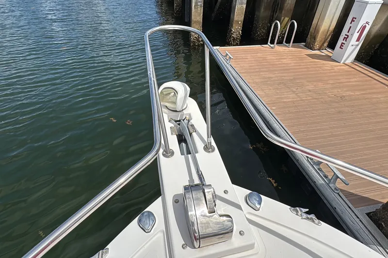Slide: The Image of Bow of 2019 Steiger Craft 255 Miami boat docked by wooden pier. - 25