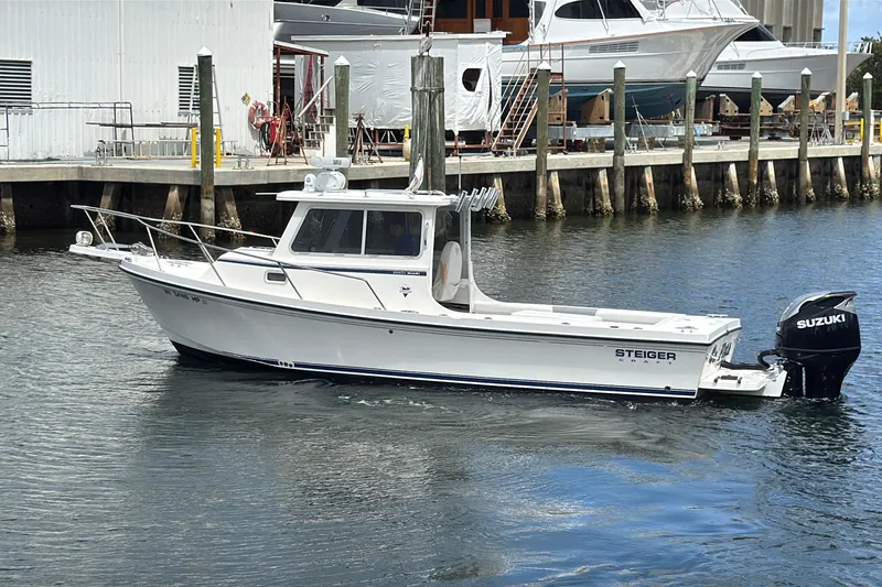 Slide: The Image of 2019 Steiger Craft 255 Miami boat with Suzuki outboard motor docked in marina. - 3