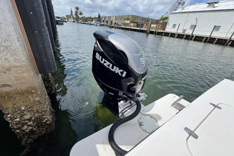 Slide: The Image of 2019 Steiger Craft 255 Miami with Suzuki outboard motor docked by waterfront. - 5