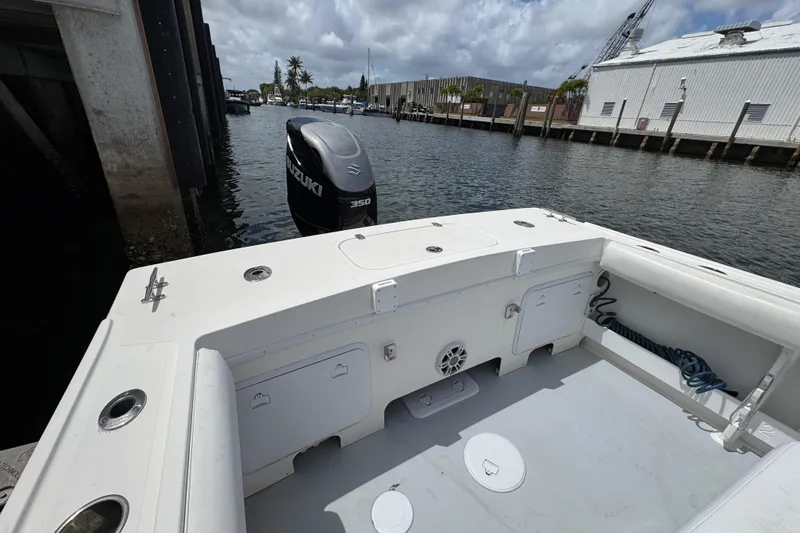 Slide: The Image of 2019 Steiger Craft 255 Miami boat with Suzuki 350 engine docked by a marina. - 6