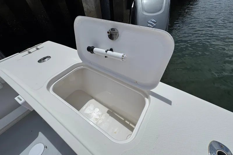 Slide: The Image of Open storage compartment on 2019 Steiger Craft 255 Miami boat, near water. - 7