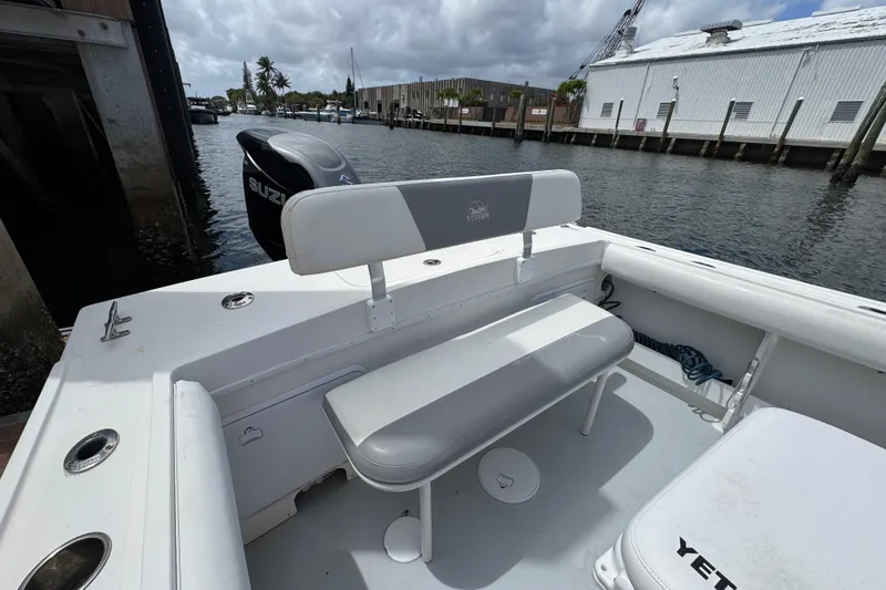 Slide: The Image of 2019 Steiger Craft 255 Miami boat interior with seating and Suzuki outboard motor. - 8