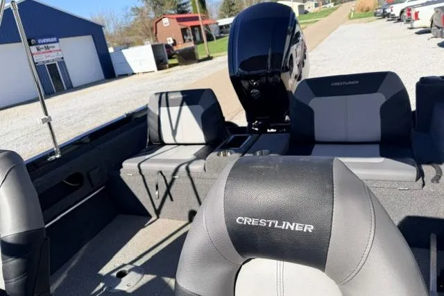 Slide: The Image of 2022 Crestliner 1750 Fish Hawk SE interior with seating and motor, parked outdoors. - 19