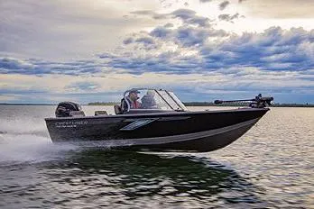 Slide: The Image of Manufacturer Provided Image: 2022 Crestliner 1750 Fish Hawk SE speeding on a lake under a cloudy sky. - 2