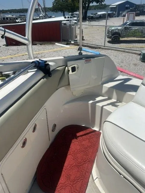Slide: The Image of Interior of a 2006 Sea Ray 240 Sundeck boat with red carpet. - 11