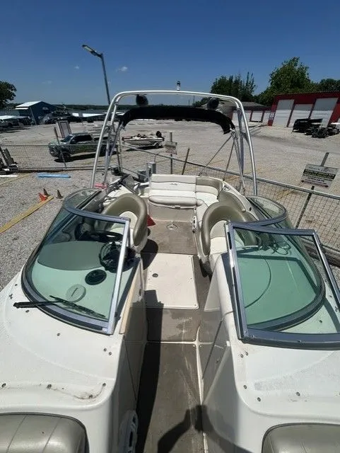 Slide: The Image of 2006 Sea Ray 240 Sundeck boat in a parking area. - 3
