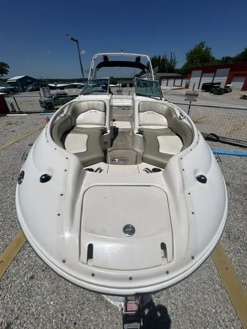 Slide: The Image of 2006 Sea Ray 240 Sundeck boat on a trailer outdoors. - 6