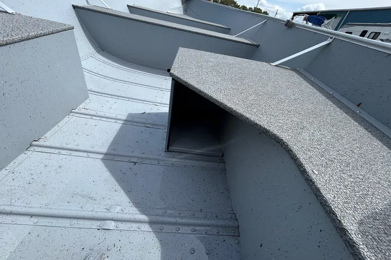 Slide: The Image of Interior view of 2026 Crestliner 1672 Outreach boat, showcasing textured flooring and seating. - 10
