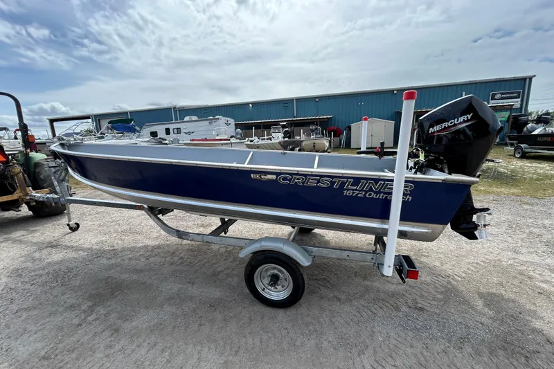 Slide: The Image of 2026 Crestliner 1672 Outreach boat on trailer with Mercury outboard motor. - 2