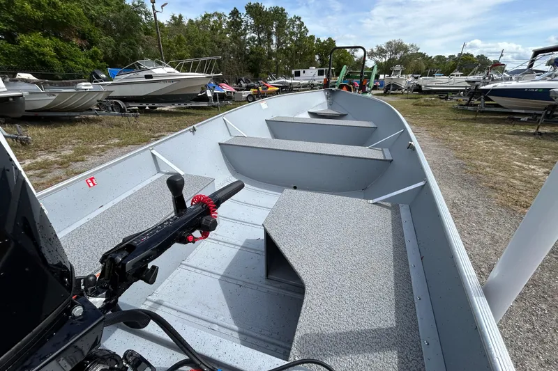 Slide: The Image of 2026 Crestliner 1672 Outreach boat in a marina, showcasing interior seating and controls. - 8