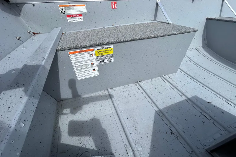 Slide: The Image of Interior of 2026 Crestliner 1672 Outreach boat with safety labels and seating. - 9