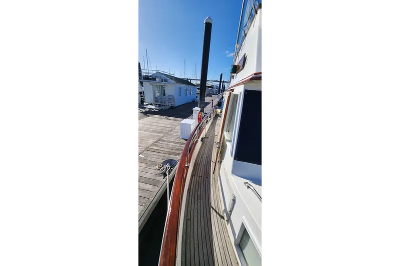 Slide: The Image of Side view of 1987 Grand Banks 36 Classic yacht docked at marina. - 15
