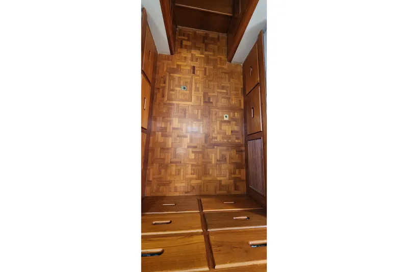Slide: The Image of Wooden interior of 1987 Grand Banks 36 Classic boat with parquet flooring and storage cabinets. - 18