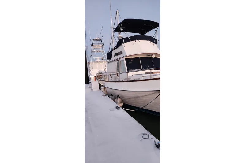 Slide: The Image of 1987 Grand Banks 36 Classic yacht docked at marina, side view. - 2
