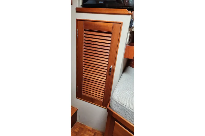 Slide: The Image of Wooden louvered cabinet door inside 1987 Grand Banks 36 Classic boat interior. - 20