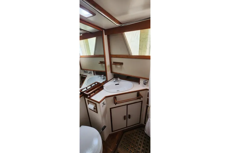 Slide: The Image of Bathroom interior of 1987 Grand Banks 36 Classic yacht with wooden accents and sink. - 24
