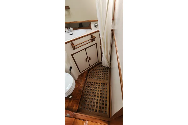 Slide: The Image of Bathroom interior of 1987 Grand Banks 36 Classic yacht, featuring wooden accents and a shower area. - 25
