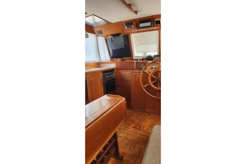 Slide: The Image of Interior of 1987 Grand Banks 36 Classic yacht with wooden helm and cabinetry. - 26