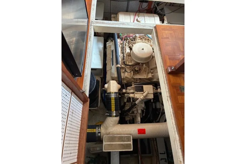 Slide: The Image of Engine compartment of a 1987 Grand Banks 36 Classic boat, showcasing detailed machinery. - 28
