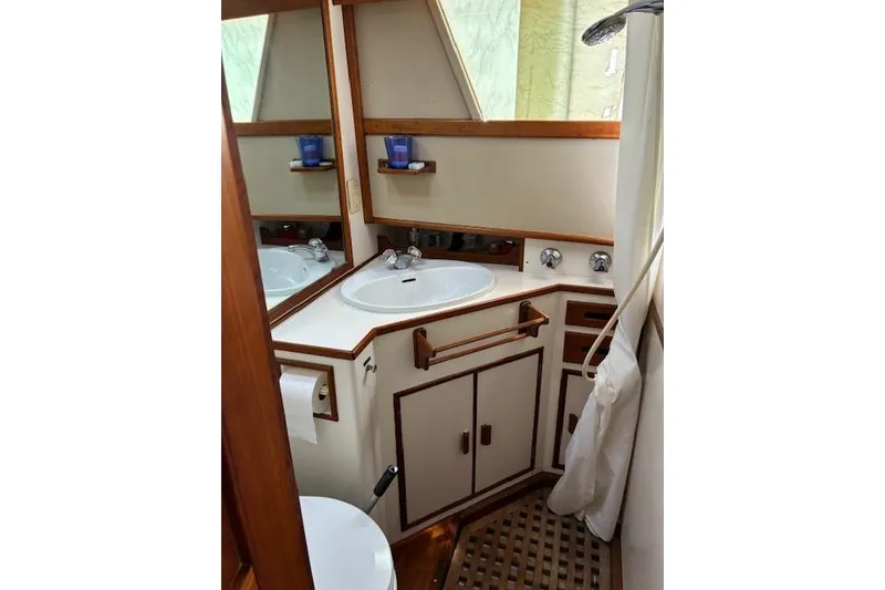 Slide: The Image of Bathroom interior of 1987 Grand Banks 36 Classic yacht, featuring sink and wooden accents. - 39