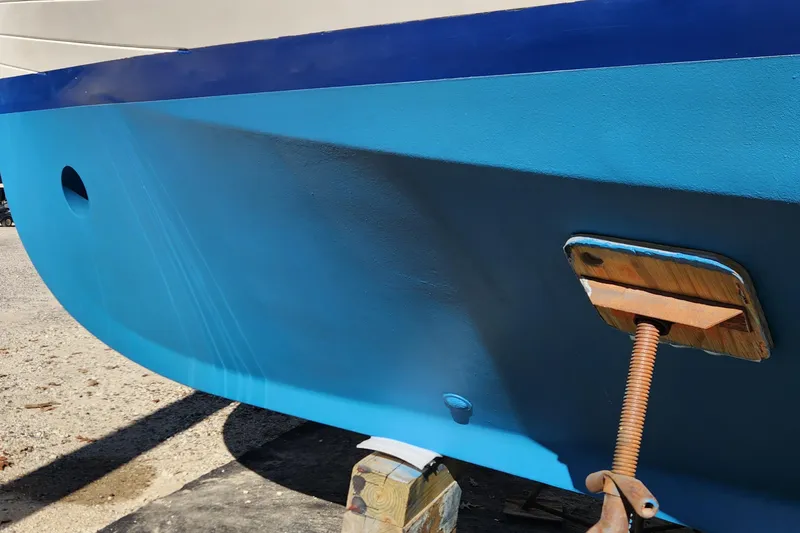Slide: The Image of Blue hull of 1987 Grand Banks 36 Classic boat on dry dock. - 42