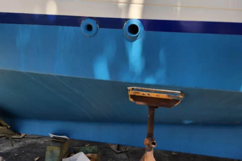 Slide: The Image of 1987 Grand Banks 36 Classic boat hull with blue paint and support stand. - 6