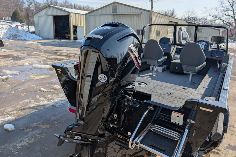 Slide: The Image of 2026 Starcraft Storm 176 DC Pro boat with Mercury outboard motor in snowy yard. - 2