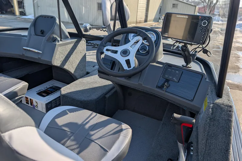 Slide: The Image of Interior of 2026 Starcraft Storm 176 DC Pro boat with steering wheel and navigation system. - 4