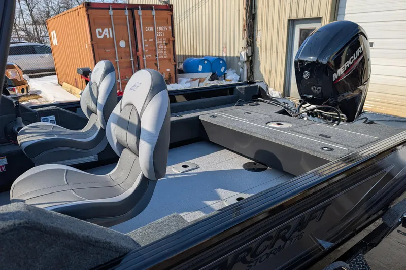 Slide: The Image of 2026 Starcraft Storm 176 DC Pro boat interior with Mercury engine, featuring two gray seats. - 8