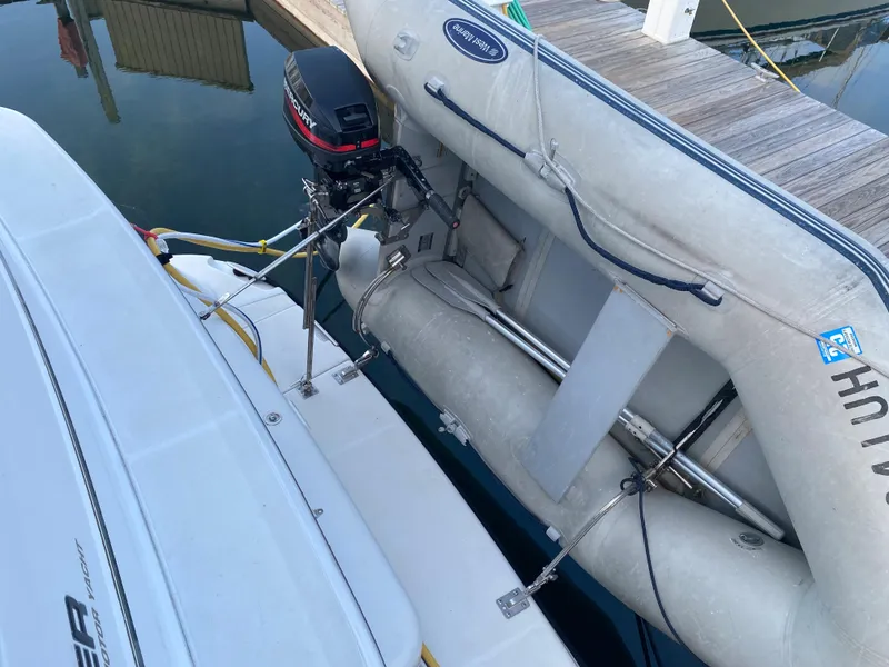 Slide: The Image of 2000 Carver 396 Motor Yacht with attached inflatable dinghy at dock. - 14