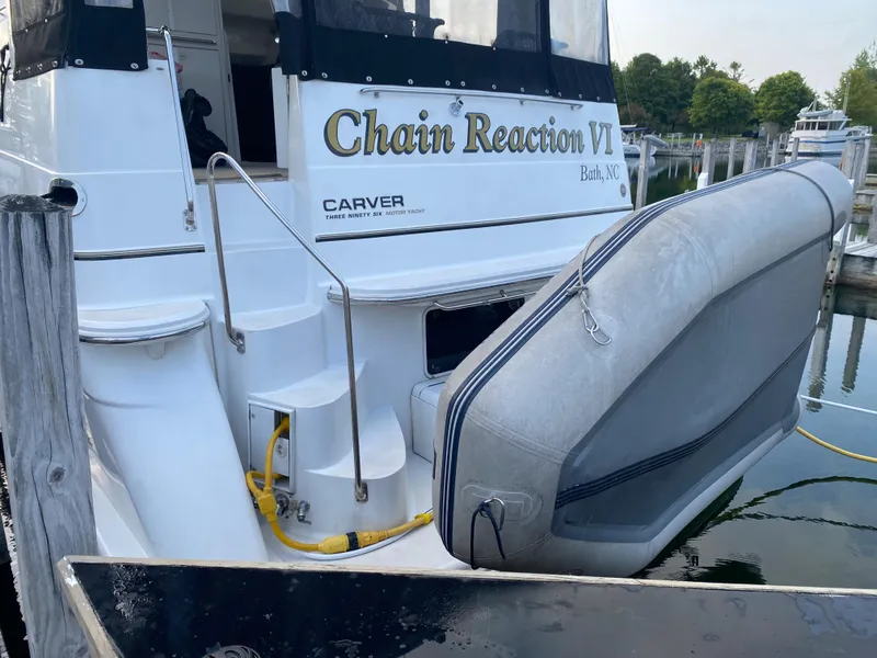 Slide: The Image of 2000 Carver 396 Motor Yacht Chain Reaction VI docked with inflatable boat. - 2