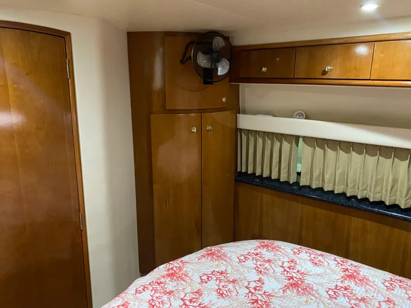 Slide: The Image of 2000 Carver 396 Motor Yacht interior cabin with wood cabinetry and bed. - 26