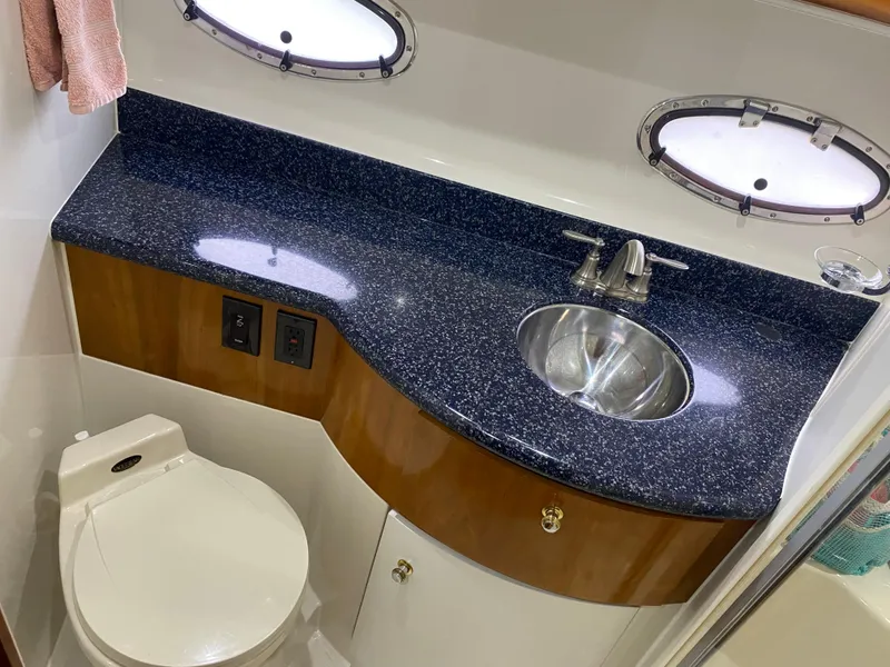 Slide: The Image of 2000 Carver 396 Motor Yacht bathroom with granite countertop and stainless steel sink. - 27