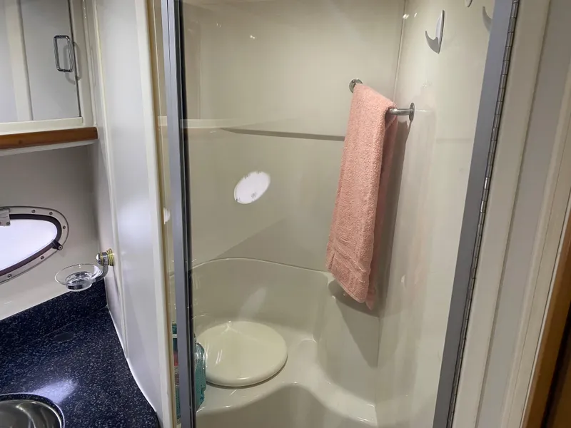 Slide: The Image of Bathroom of 2000 Carver 396 Motor Yacht with shower, sink, and towel rack. - 28