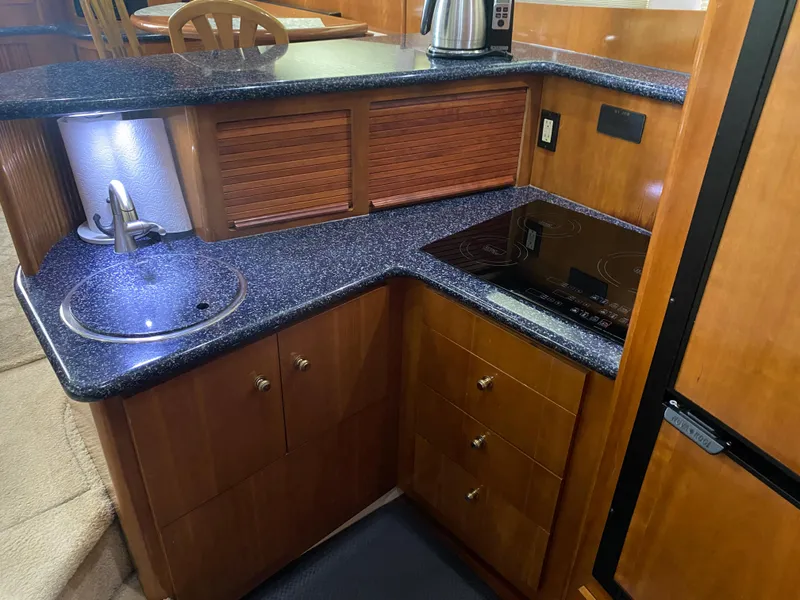 Slide: The Image of 2000 Carver 396 Motor Yacht kitchen with granite countertops and modern appliances. - 33