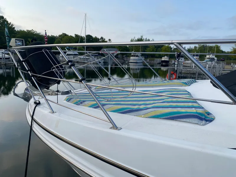 Slide: The Image of 2000 Carver 396 Motor Yacht docked at a marina with striped deck cushions. - 4