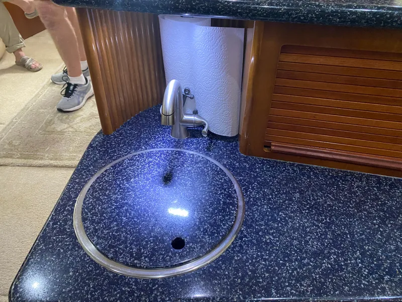 Slide: The Image of Carver 396 Motor Yacht 2000 kitchen area with sink and faucet. - 49