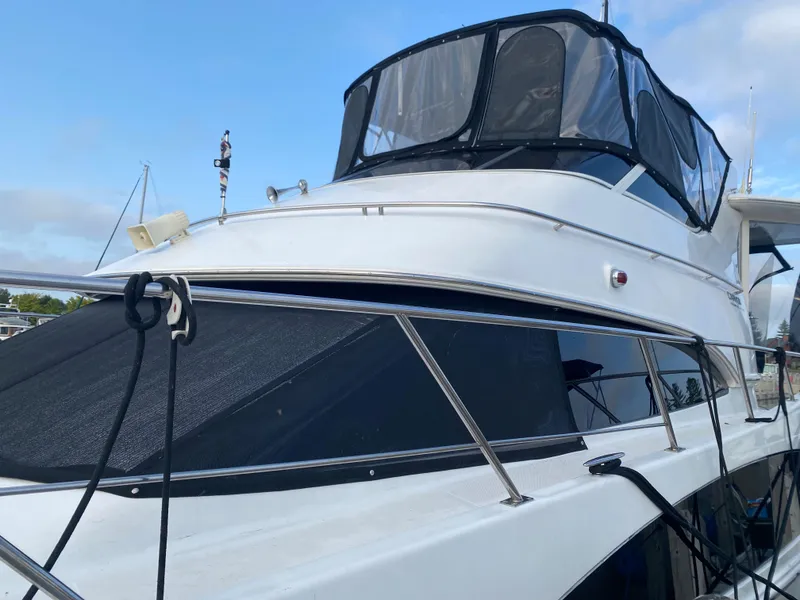 Slide: The Image of 2000 Carver 396 Motor Yacht docked, side view with clear skies. - 5