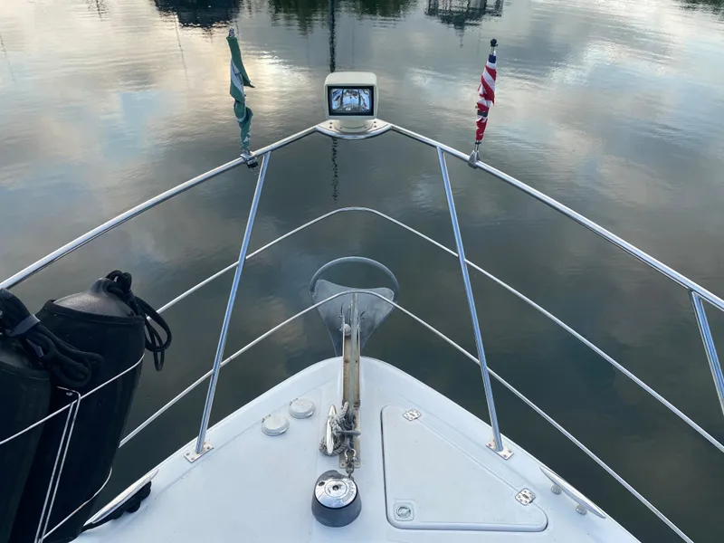 Slide: The Image of Bow view of a 2000 Carver 396 Motor Yacht on calm water. - 8