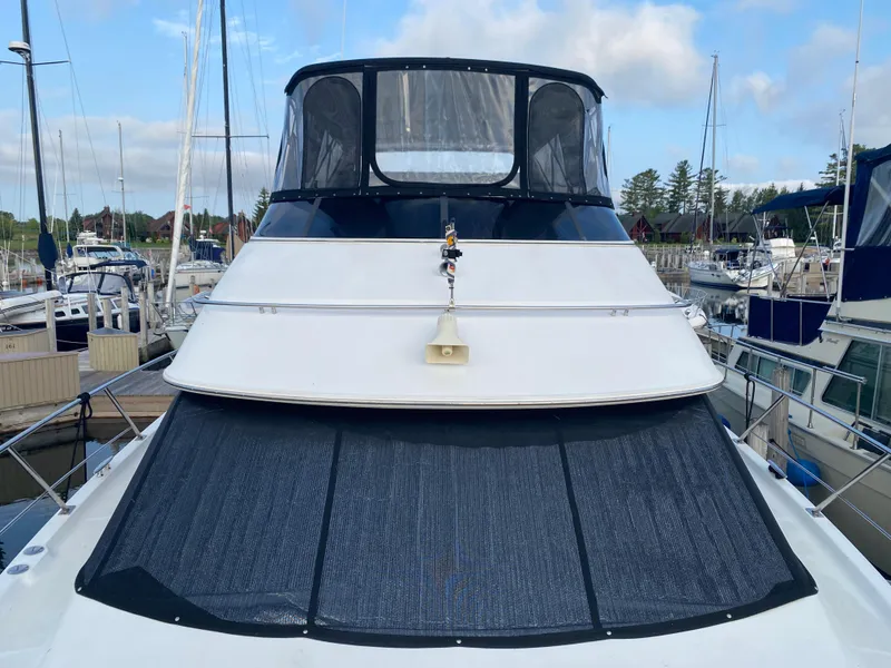 Slide: The Image of 2000 Carver 396 Motor Yacht docked at a marina with other boats. - 9