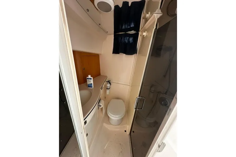 Slide: The Image of Compact bathroom in a 2004 Intrepid 377 Walkaround boat with shower and toilet. - 10