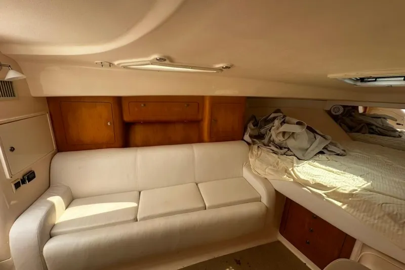 Slide: The Image of Interior of a 2004 Intrepid 377 Walkaround boat with sofa and bed. - 13