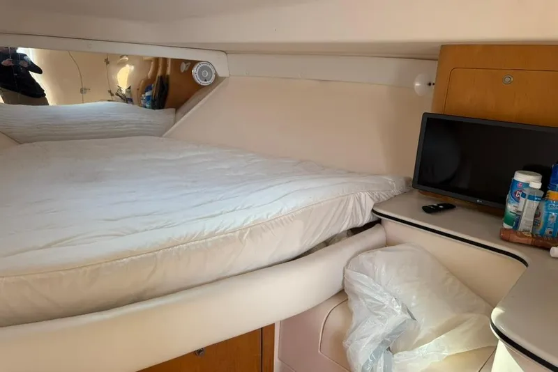 Slide: The Image of Cozy cabin interior of 2004 Intrepid 377 Walkaround with bed, TV, and storage. - 14