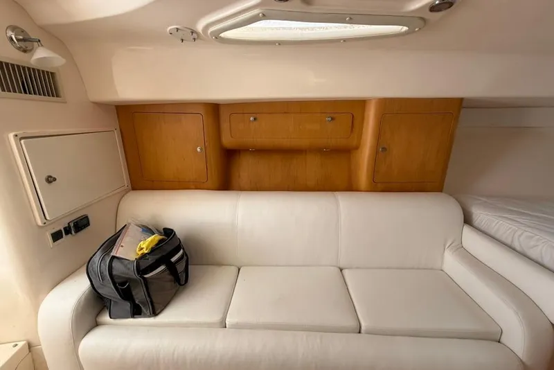 Slide: The Image of Interior of 2004 Intrepid 377 Walkaround with white leather seating and wooden cabinets. - 15