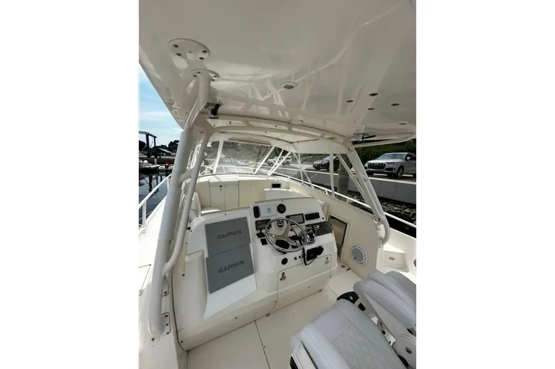 Slide: The Image of 2004 Intrepid 377 Walkaround boat cockpit with Garmin navigation system and seating. - 5