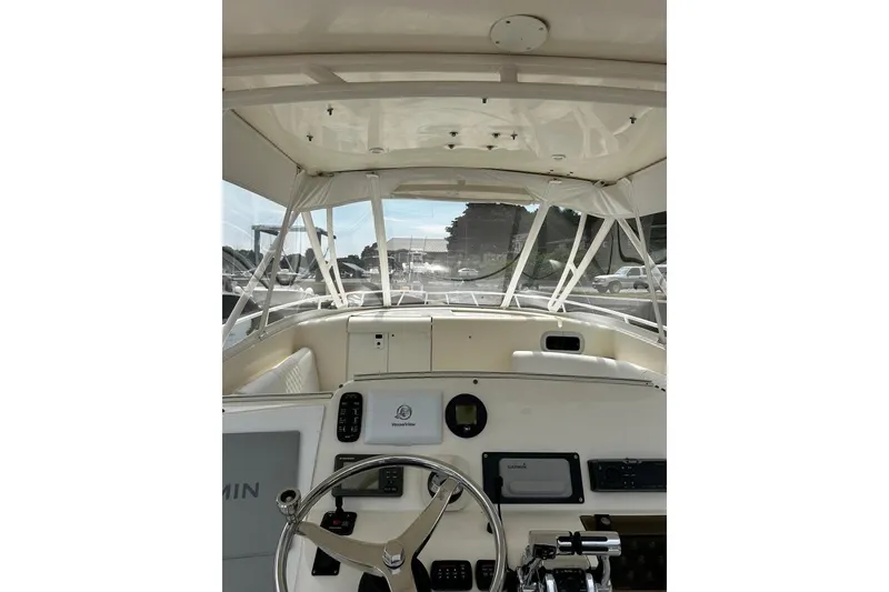 Slide: The Image of 2004 Intrepid 377 Walkaround boat cockpit with steering wheel and navigation equipment. - 6