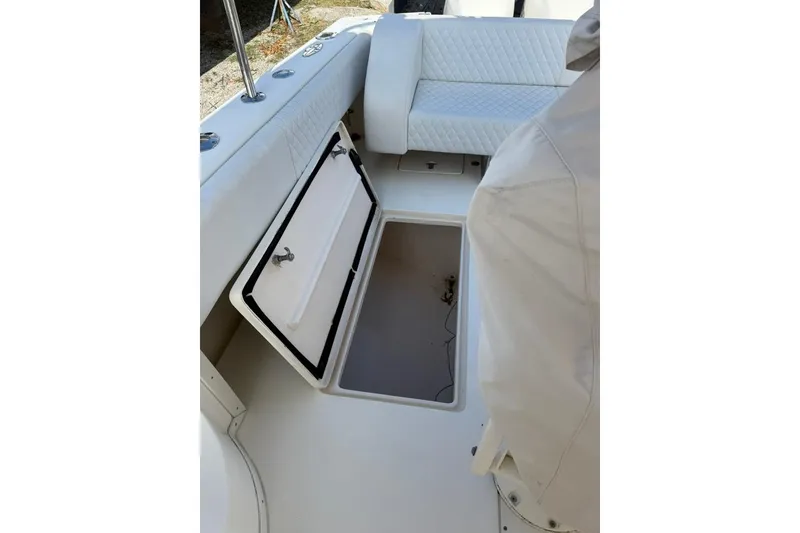 Slide: The Image of 2004 Intrepid 377 Walkaround boat interior with open storage compartment. - 9